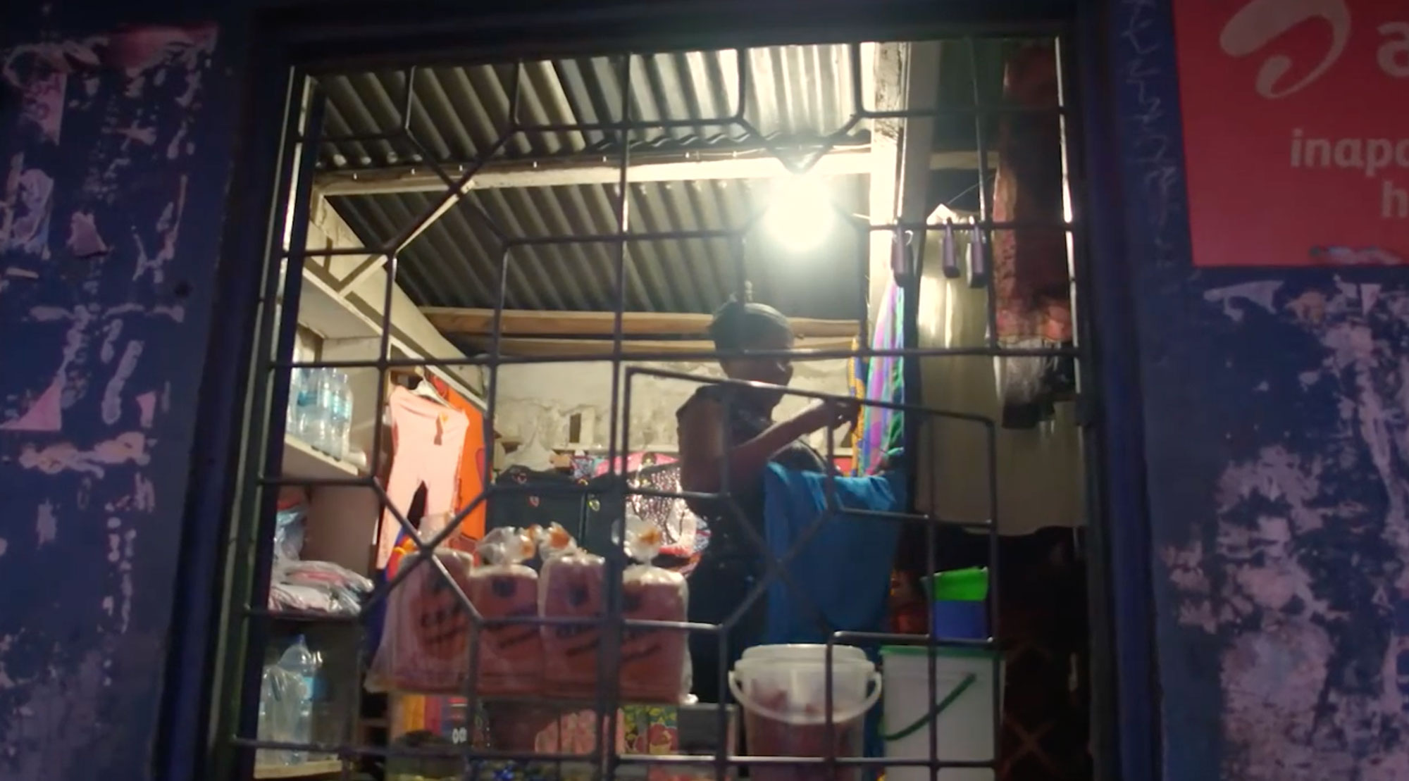 Matilda hangs clothes in her home