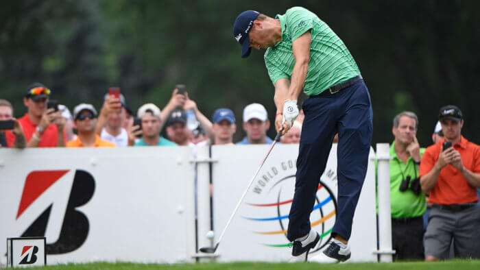 Justin Thomas hits a golf ball in a tournament