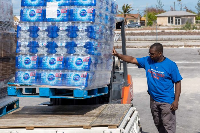 A Convoy of Hope volunteer distributes water