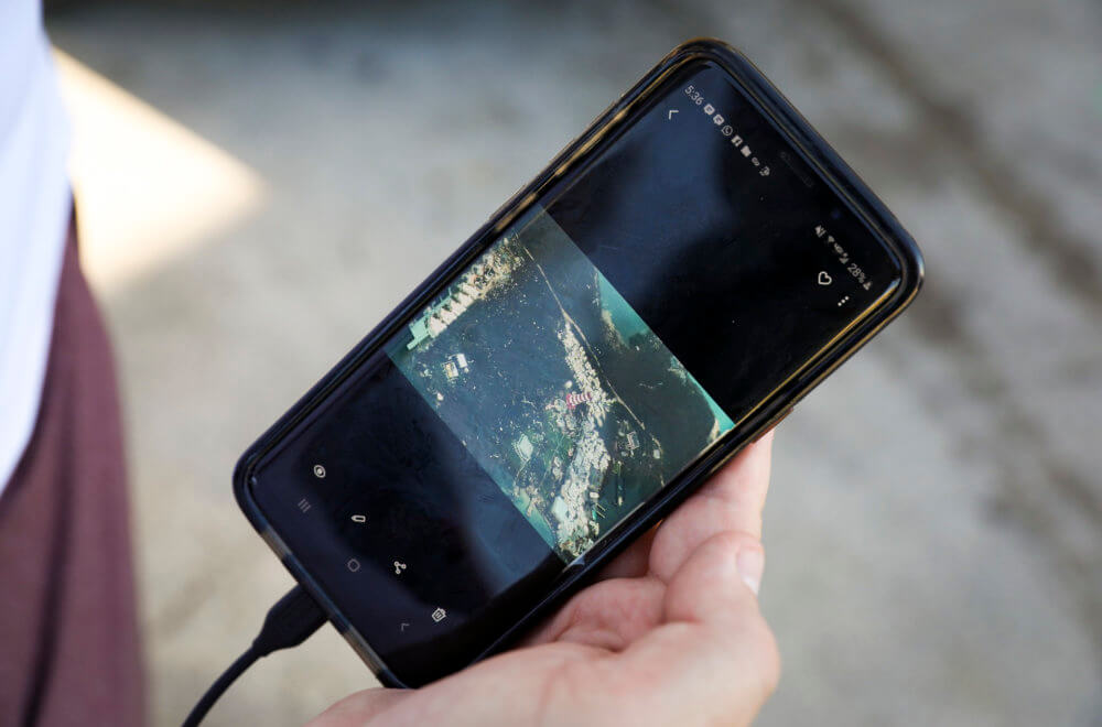 Convoy of Hope team member surveys aerial footage of the damage in the Bahamas from their phone