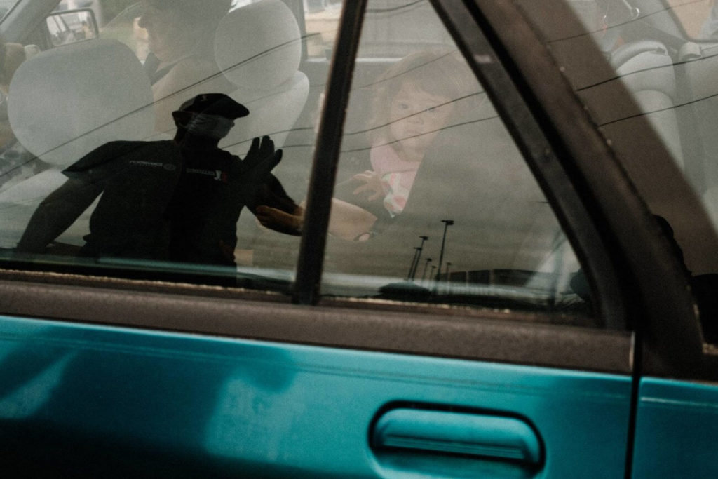 Darlington, South Carolina – A volunteer waves to those in cars as they receive food and supplies at a point of distribution