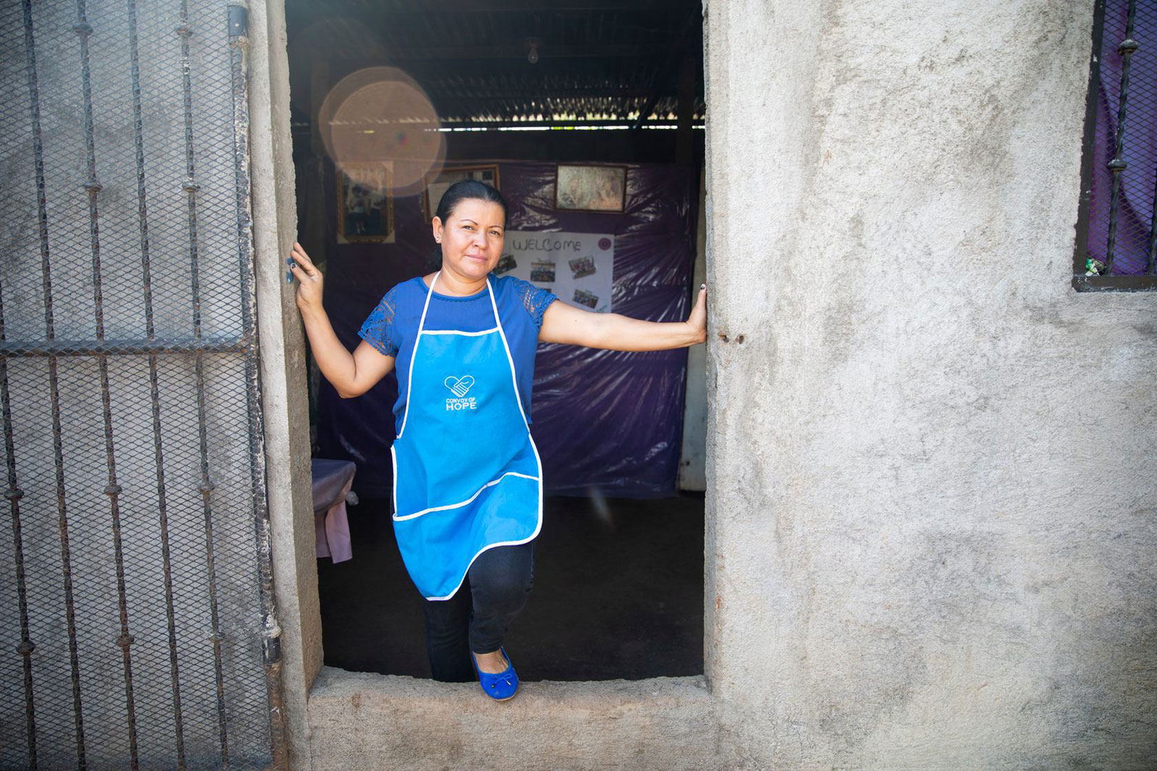 Josefina stands in doorway