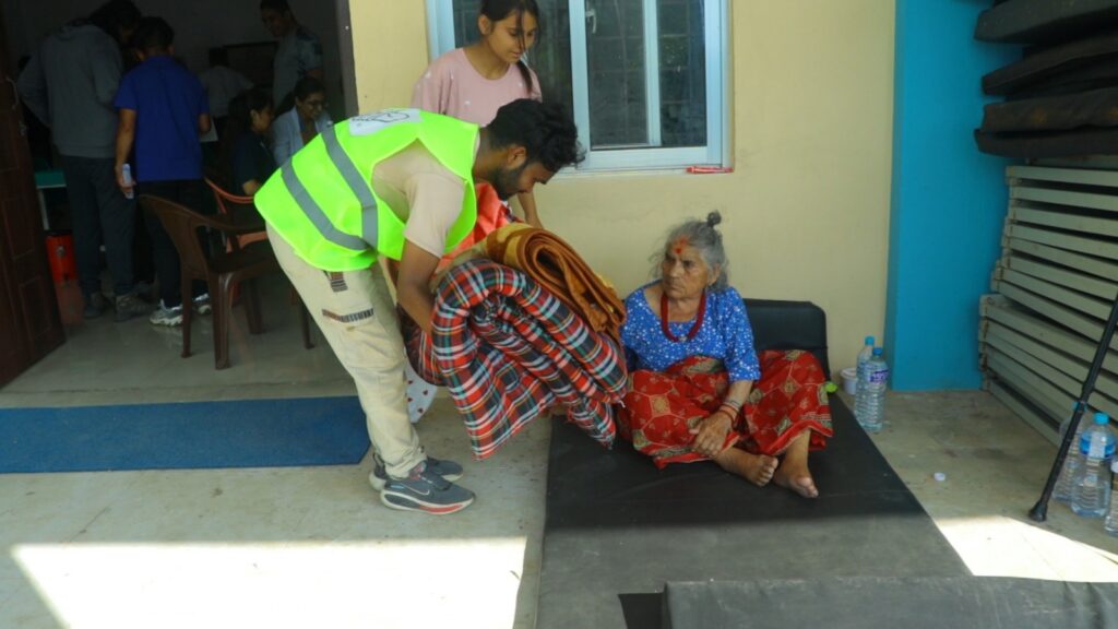 Convoy of Hope teammates give blankets to a local woman who has been displaced by the floods.